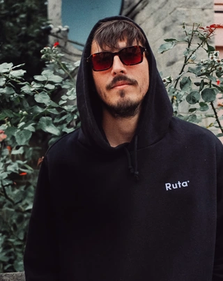 Horacio Bolz outdoors in sunglasses and a dark hoodie