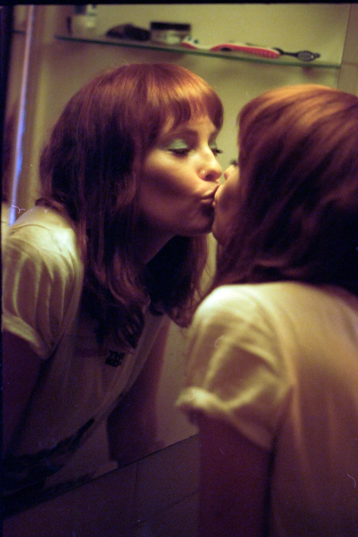 Portrait reflected in a mirror in warm interior light