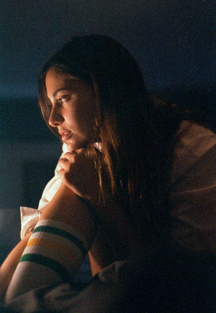 Side-lit portrait against a dark background