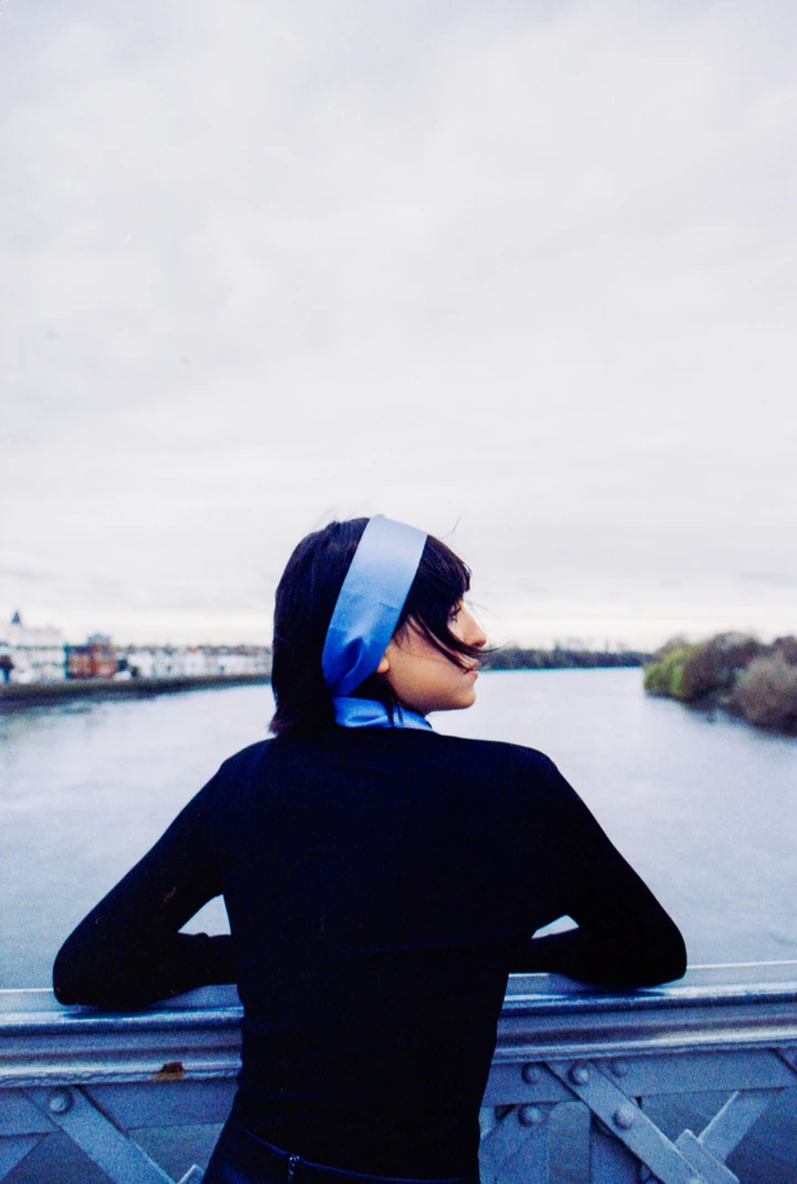 Blue-haired subject photographed beside a car