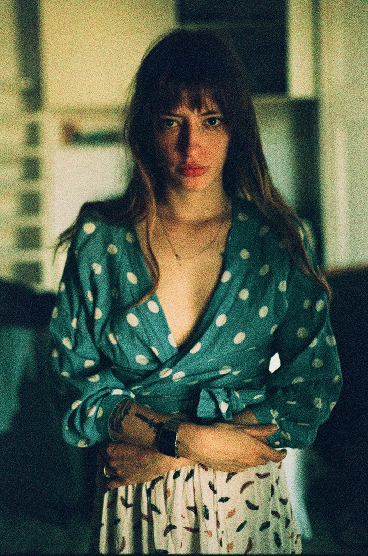 Portrait in a green patterned shirt inside a room